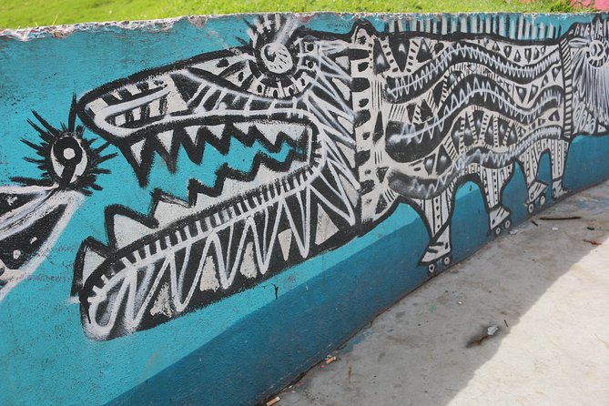 Graffiti Tour in La Candelaria Bogotá with Transportation - Indigenous ancestry murals on tight streets